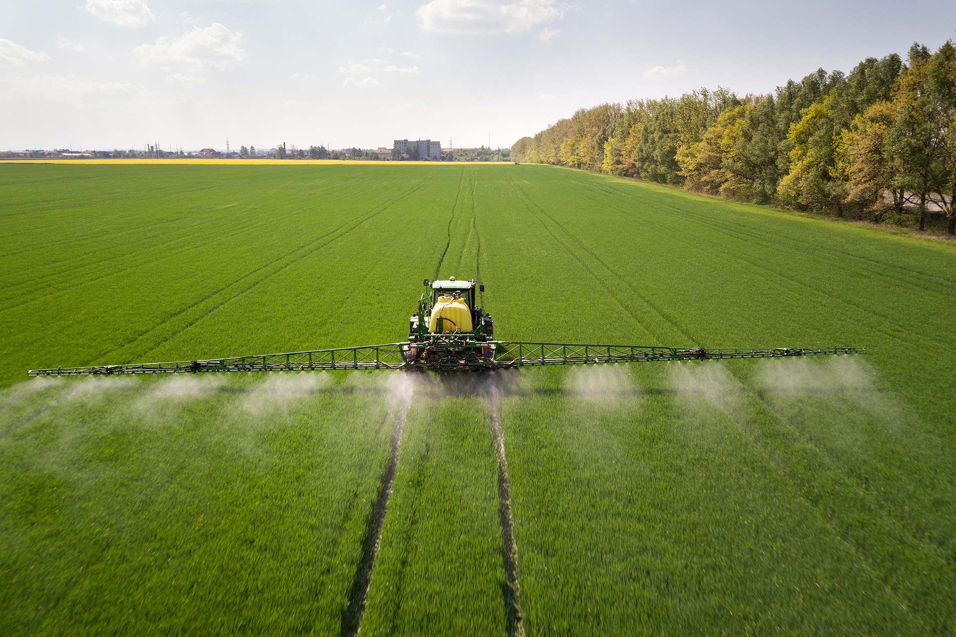 tractor-spraying-pesticides-with-sprayer-large-green-agricultural-field_1.jpg